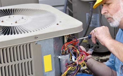 man working on an air conditioning unit